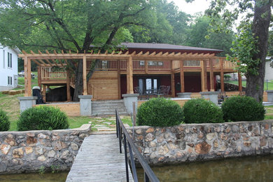 Inspiration for a craftsman backyard concrete patio remodel in Other with a pergola