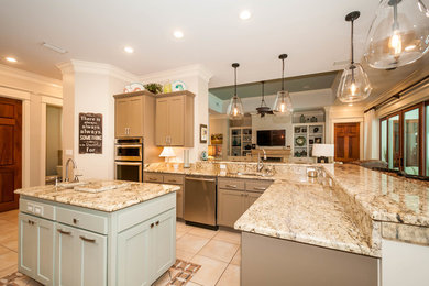 Large transitional u-shaped ceramic tile open concept kitchen photo in Miami with a double-bowl sink, recessed-panel cabinets, gray cabinets, granite countertops, multicolored backsplash, matchstick tile backsplash, stainless steel appliances and an island