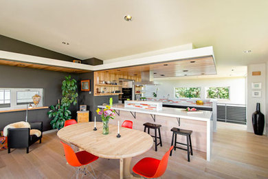Example of a trendy light wood floor dining room design in Other with gray walls and no fireplace