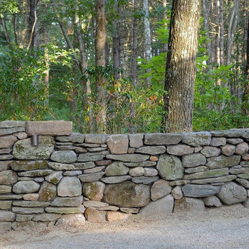 New England fieldstone wall with battered pier and low voltage lighting.