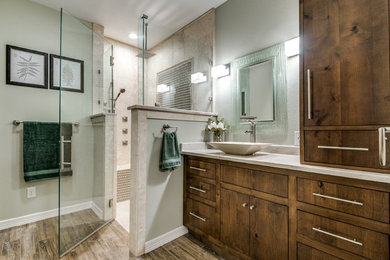 Inspiration for a mid-sized country master bathroom in Austin with flat-panel cabinets, medium wood cabinets, a corner shower, beige tile, travertine, beige walls, medium hardwood floors, a vessel sink and granite benchtops.