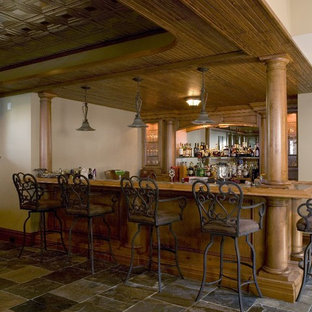 Photo of an expansive classic look-out basement in Chicago with slate flooring, beige walls and grey floors.