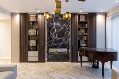 Photo of a large modern formal and cream and black open plan living room in London with feature lighting.