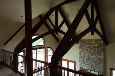 Inspiration for a mid-sized rustic carpeted and brown floor hallway remodel in Chicago with gray walls
