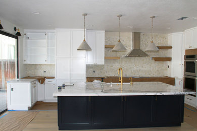 Inspiration for a huge contemporary u-shaped light wood floor and beige floor open concept kitchen remodel in San Diego with a single-bowl sink, shaker cabinets, white cabinets, marble countertops, multicolored backsplash, stone tile backsplash, stainless steel appliances, an island and white countertops