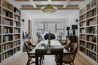 Small transitional freestanding desk light wood floor, beige floor, coffered ceiling and wallpaper study room photo in New York with beige walls