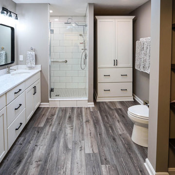 All White Bathroom with Black Hardware and Gray Flooring