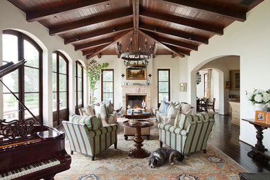 Tuscan dark wood floor living room photo in Los Angeles with a music area, white walls and a standard fireplace