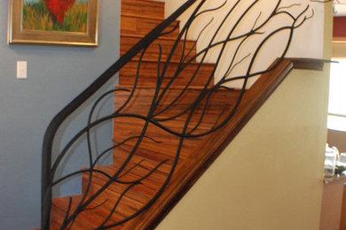 This is an example of a mid-sized traditional wood l-shaped staircase in Houston with wood risers and metal railing.