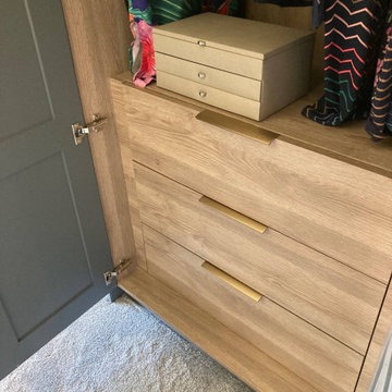 An elegant pipe grey bedroom with cloudy oak and bespoke storage solutions
