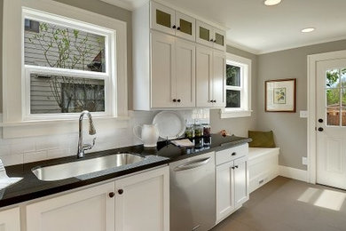Inspiration for a mid-sized contemporary single-wall porcelain tile kitchen remodel in Other with an undermount sink, flat-panel cabinets, white cabinets, granite countertops, white backsplash, subway tile backsplash, stainless steel appliances and no island