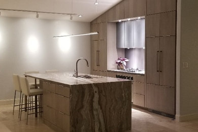 Photo of a mid-sized contemporary open plan kitchen in Other with an undermount sink, flat-panel cabinets, medium wood cabinets, marble benchtops, grey splashback, panelled appliances, travertine floors, with island, beige floor and multi-coloured benchtop.