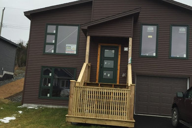 Inspiration for a small contemporary brown one-story vinyl house exterior remodel in Other with a shed roof and a shingle roof