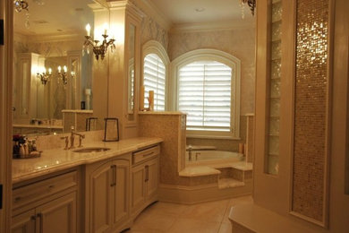 Inspiration for a mid-sized traditional master bathroom in Little Rock with an undermount sink, raised-panel cabinets, white cabinets, marble benchtops, a corner tub, a double shower, white tile, white walls, marble floors and a two-piece toilet.