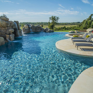 Infinity Edge Pool with Island, Slide, Waterfalls, and Spa