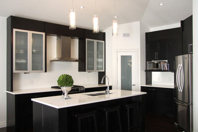 Eat-in kitchen - mid-sized modern u-shaped dark wood floor eat-in kitchen idea in Other with an undermount sink, glass-front cabinets, quartz countertops, stainless steel appliances, an island, dark wood cabinets, white backsplash and stone slab backsplash