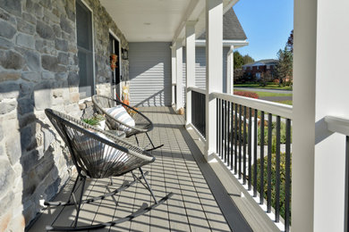 This is an example of a mid-sized craftsman brick mixed material railing porch design in New York with a roof extension.