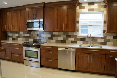 Inspiration for a mid-sized timeless l-shaped porcelain tile and gray floor open concept kitchen remodel in Houston with a double-bowl sink, shaker cabinets, medium tone wood cabinets, quartz countertops, beige backsplash, ceramic backsplash, stainless steel appliances and an island