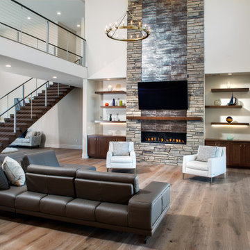 75 Family Room with a Stacked Stone Fireplace and a Wall-Mounted TV ...