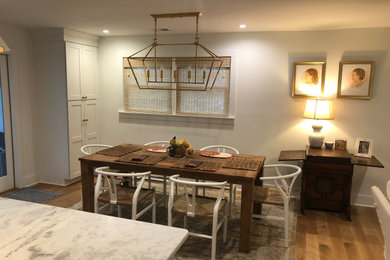 Elegant light wood floor and brown floor kitchen/dining room combo photo in Charleston with yellow walls