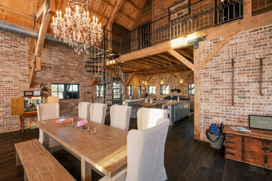 Inspiration for a rustic brick floor, brown floor, vaulted ceiling, wood ceiling and brick wall great room remodel in Other with red walls