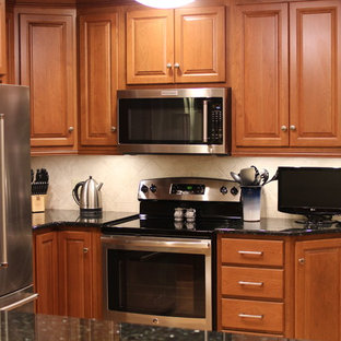 Small traditional kitchen pantry remodeling - Inspiration for a small timeless u-shaped medium tone wood floor kitchen pantry remodel in Columbus with stainless steel appliances, raised-panel cabinets, dark wood cabinets, granite countertops, beige backsplash, ceramic backsplash and an island