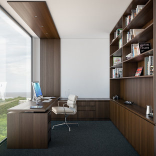 Design ideas for a medium sized modern study in Melbourne with white walls, carpet and a built-in desk.