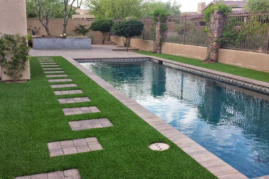 Example of a mid-sized transitional backyard brick and rectangular lap pool design in San Diego