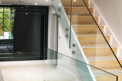 This is an example of a staircase in Other with glass railing.