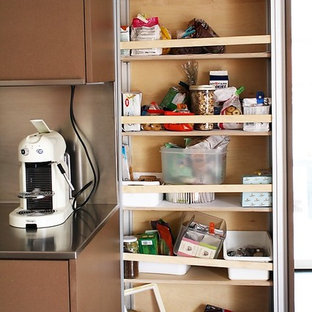 Huge contemporary kitchen pantry appliance - Huge trendy concrete floor and gray floor kitchen pantry photo in Milan with a single-bowl sink, flat-panel cabinets, brown cabinets, stainless steel countertops, metallic backsplash, paneled appliances and two islands