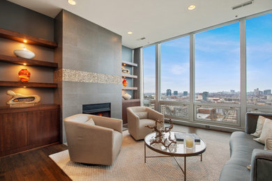 Inspiration for a contemporary dark wood floor and brown floor living room remodel in Chicago with gray walls and a standard fireplace