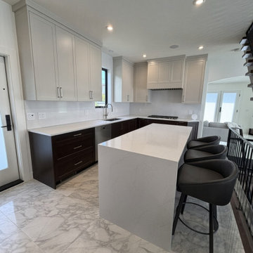 Two-Tone Kitchen with Statuario Waterfall Island and Ceiling-Height Cabinets
