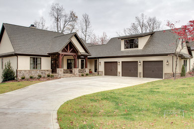 Arts and crafts beige stucco gable roof photo in Charlotte