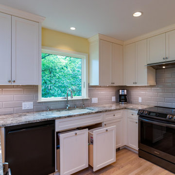 Modern Kitchen With White Painted Shaker Style Cabinets With a Bevel