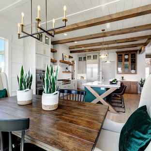 Design ideas for a mid-sized country open plan dining in Boise with white walls, light hardwood floors, no fireplace and beige floor.