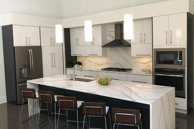 Mid-sized minimalist l-shaped eat-in kitchen photo in Other with white cabinets and an island