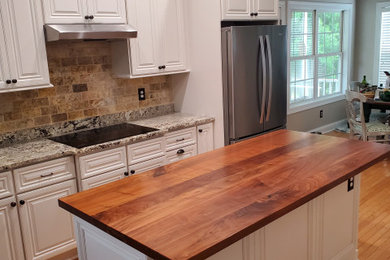 Example of a large classic u-shaped eat-in kitchen design in Charleston with raised-panel cabinets, white cabinets, wood countertops, brown backsplash, stone tile backsplash, an island and multicolored countertops