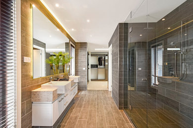 Design ideas for a contemporary master bathroom in Melbourne with flat-panel cabinets, white cabinets, a curbless shower, gray tile and a hinged shower door.