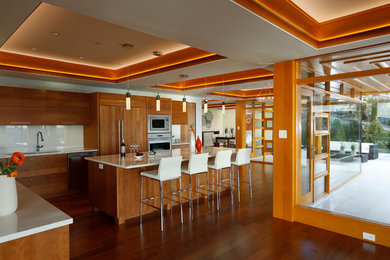 Inspiration for a large contemporary l-shaped medium tone wood floor and brown floor eat-in kitchen remodel in Vancouver with an undermount sink, flat-panel cabinets, medium tone wood cabinets, quartzite countertops, white backsplash, stone slab backsplash, stainless steel appliances and an island