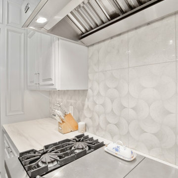 Bright and Elegant Kitchen with Glass Dining Table and Custom Cabinetry