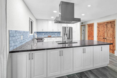 Inspiration for a large transitional u-shaped porcelain tile and gray floor open concept kitchen remodel in Orange County with shaker cabinets, subway tile backsplash, an undermount sink, white cabinets, blue backsplash, stainless steel appliances, gray countertops, quartzite countertops and no island