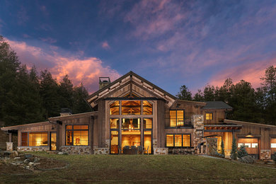 Large rustic two-story wood house exterior idea in Denver