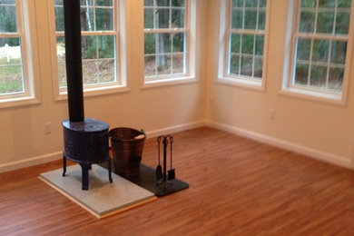 Sunroom - mid-sized traditional sunroom idea in Boston with a wood stove