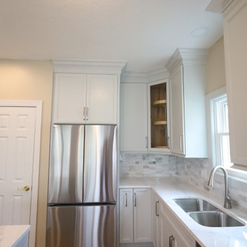 Sleek & Sophisticated: Gray Kitchen Remodel with Quartz Countertops, Marble Back