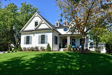 Example of a large classic white two-story mixed siding gable roof design in Chicago