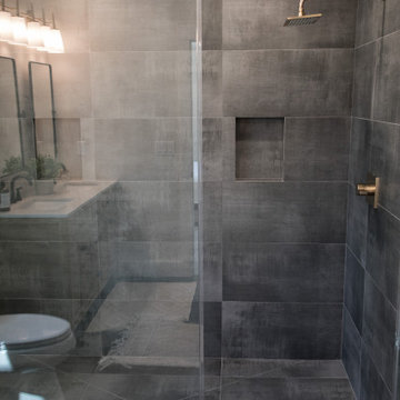 Dark Gray Tile with Gold Shower Faucets