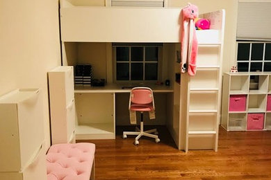 Kids' room - mid-sized traditional girl medium tone wood floor and brown floor kids' room idea in Boston with white walls