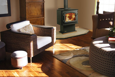 Living room - mid-sized traditional open concept medium tone wood floor living room idea in San Luis Obispo with beige walls and a wood stove