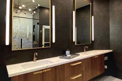 Freestanding bathtub - large contemporary master black tile and porcelain tile porcelain tile and gray floor freestanding bathtub idea in Las Vegas with flat-panel cabinets, medium tone wood cabinets, a one-piece toilet, black walls, an undermount sink, quartz countertops and white countertops