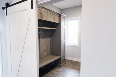 Inspiration for a transitional laminate floor entryway remodel in Calgary